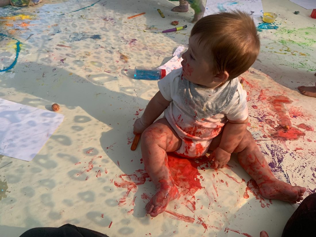 Criança a pintar com as mãos